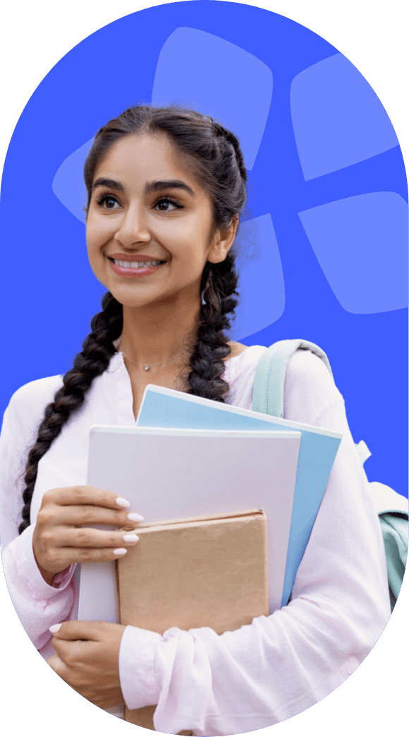 Female student smiling, holding notebooks in her hands, wearing a white blouse.